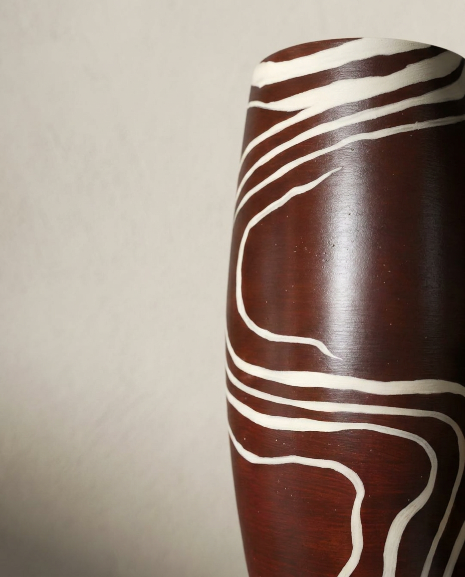 Terracotta vase with hand-painted white line motif