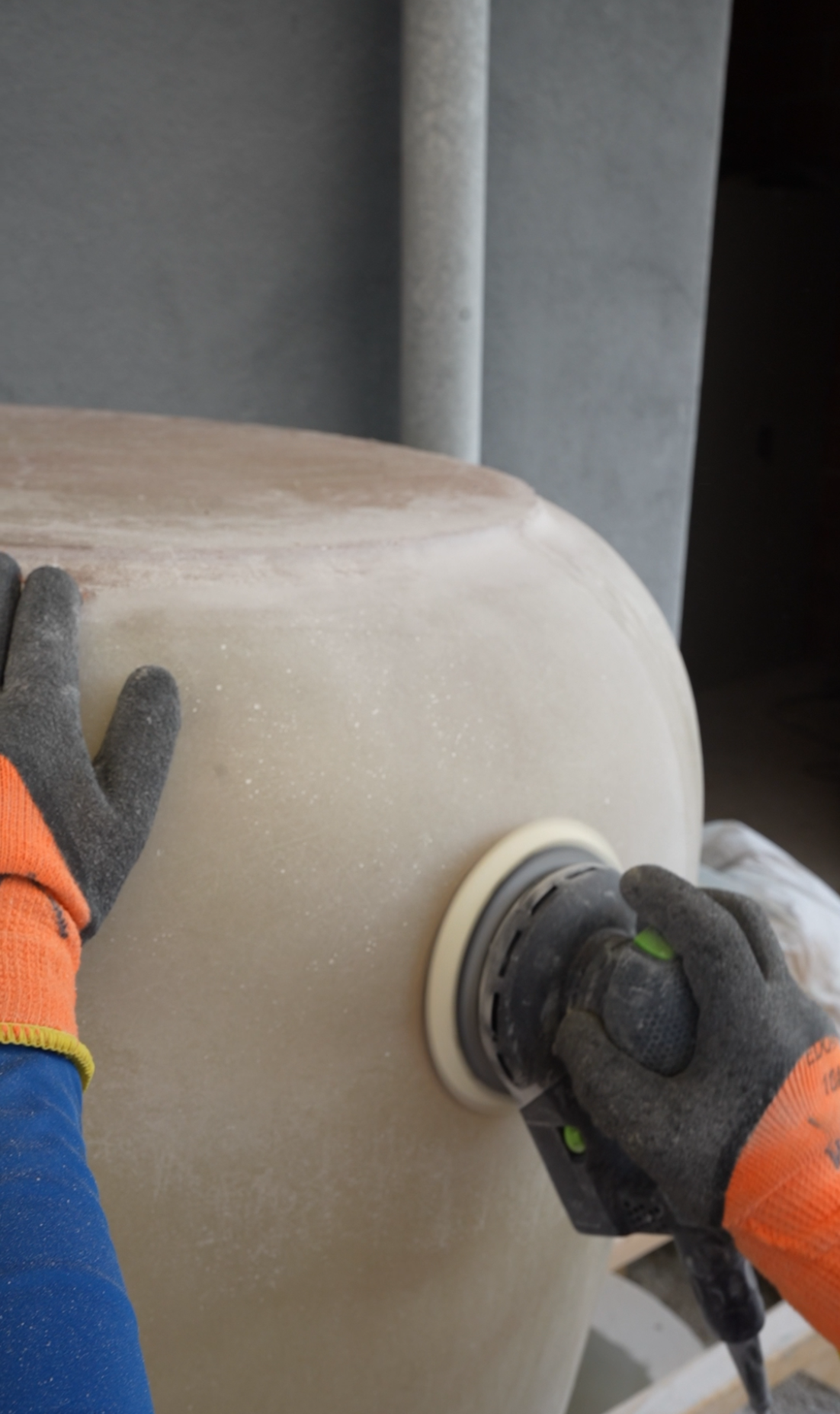 Hand-sanding a fiberglass planter